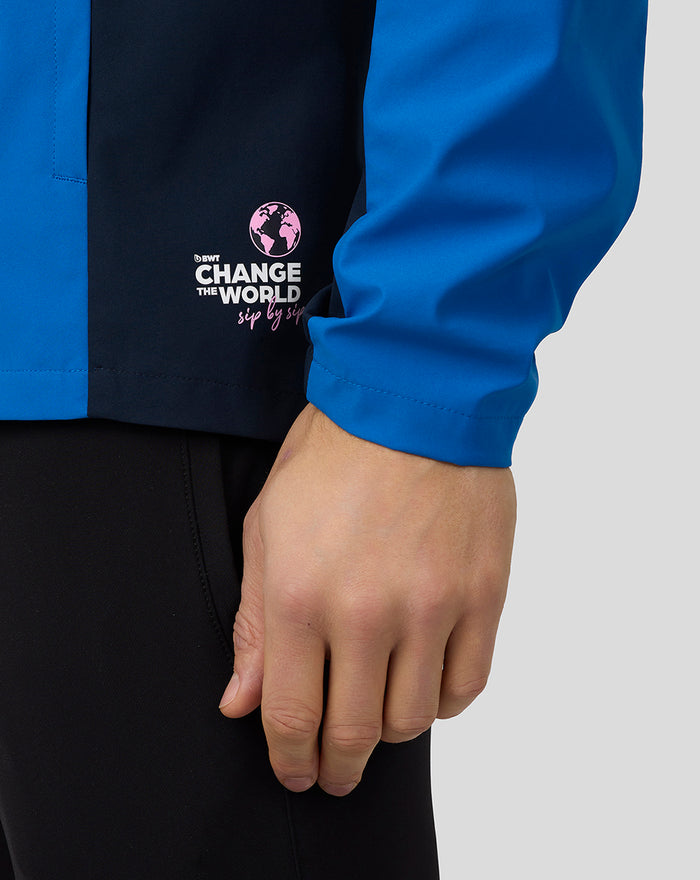 Blue jacket sleeve showing pink Change the World logo.