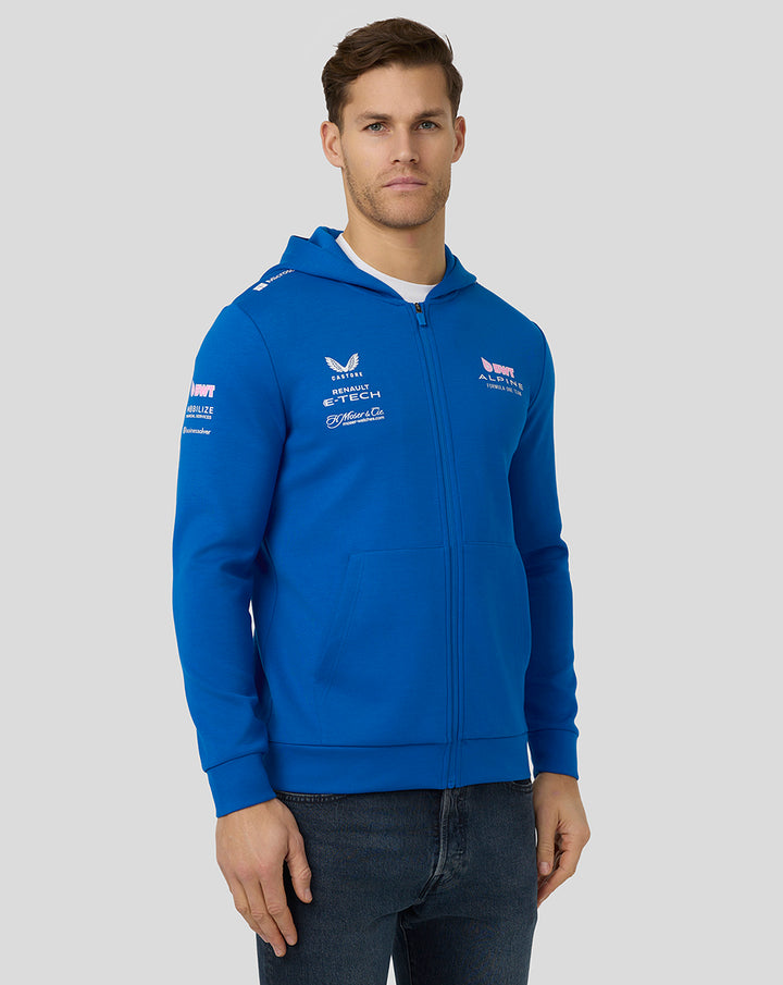 Front view of a male model in lapis blue BWT Alpine hoodie showing chest logos and the zip front