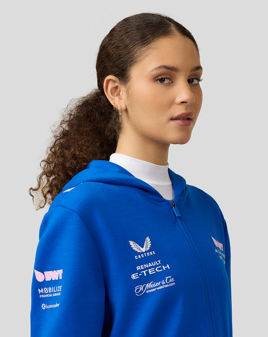 Model wearing lapis blue BWT Alpine Official Full Zip Hoodie with chest and sleeve sponsor logos