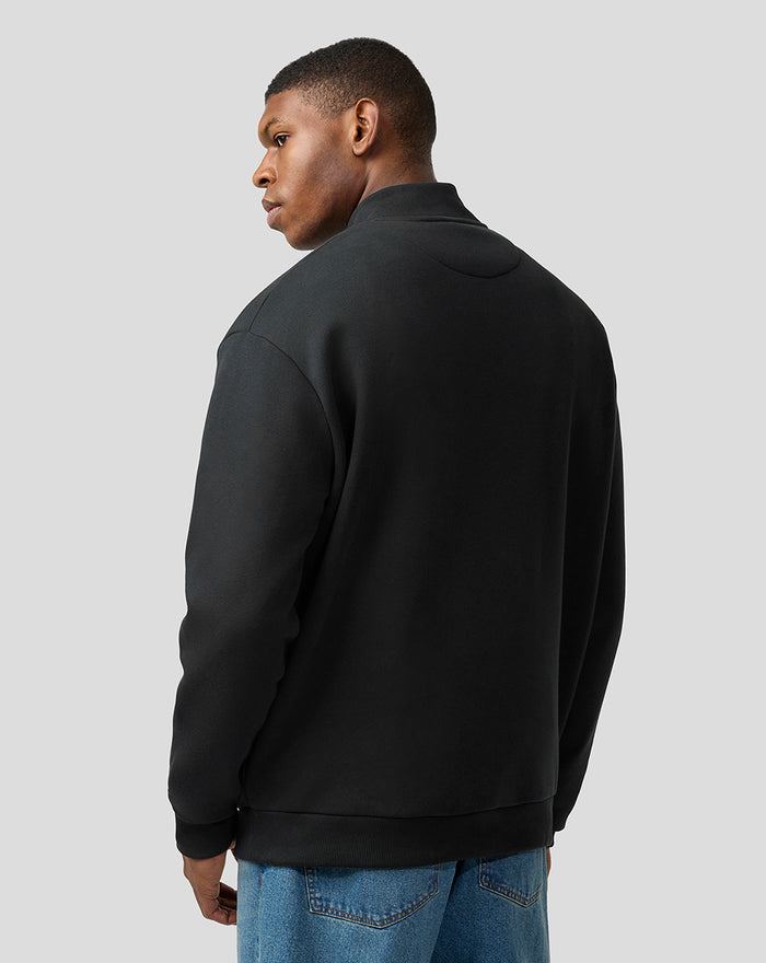 Back view of black unisex quarter-zip pullover showing relaxed fit and dropped shoulders