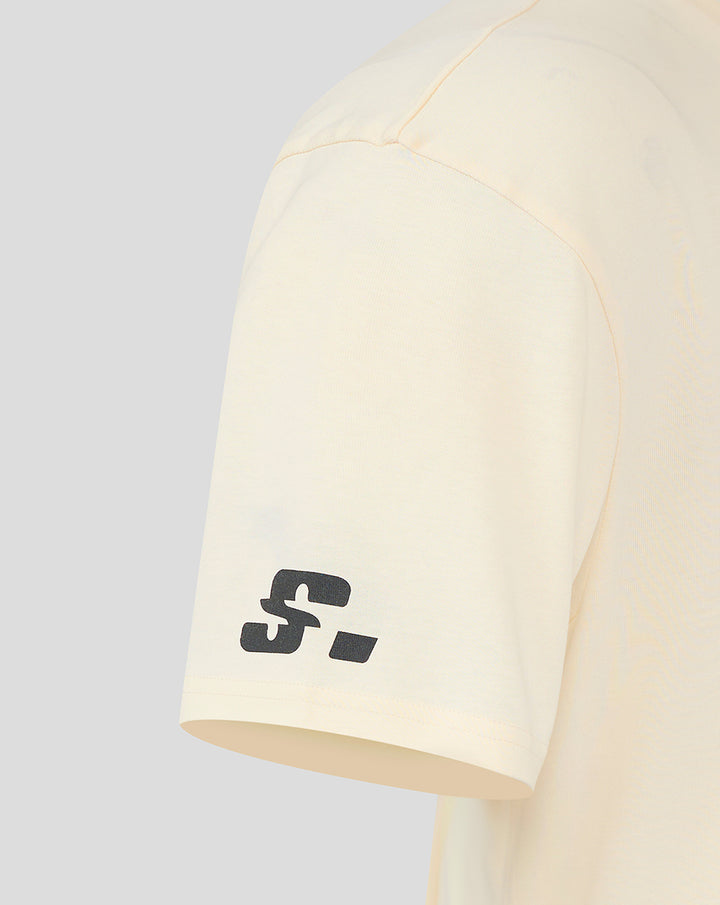 Close up of cream sleeve showing a small black graphic near the cuff.