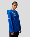 Portrait of a woman in a blue BWT Alpine Formula One Team zip hoodie with branding on the chest