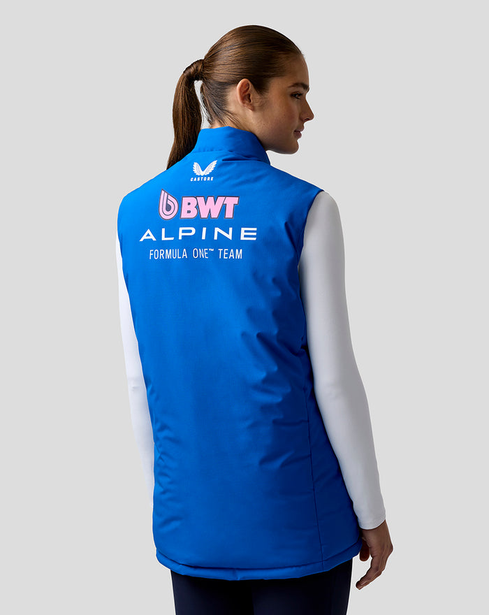 Back view of a blue BWT Alpine Formula One Team Gilet worn over a white long sleeve, with prominent logos on the back.