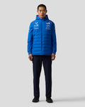 Full-body frontal view of a male model wearing a blue BWT Alpine Formula One Team Gilet with quilted front and logos on the chest.