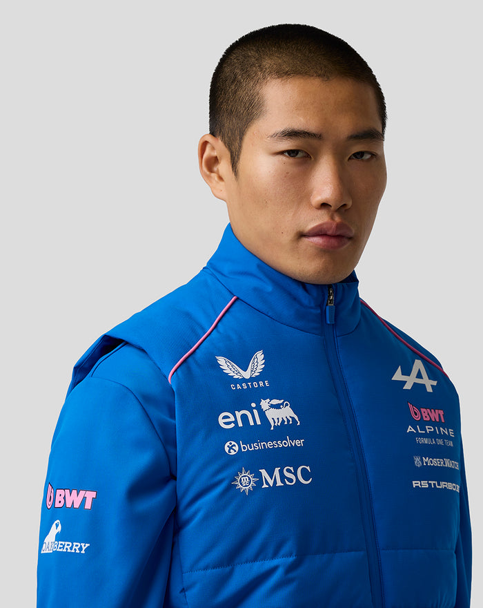Close-up of the gilet chest area showing sponsor logos on bright blue fabric.