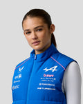 Female model wearing blue BWT Alpine Formula One Team gilet with chest logos and pink piping