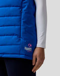 Blue BWT Alpine Formula One Team gilet with pink globe logo near hem and a zip side pocket.