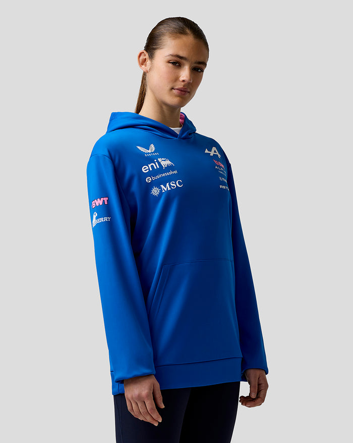 Person wearing blue Formula One Team hoodie with sponsor logos on chest and sleeve.