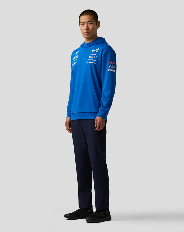 Side profile of a blue BWT Alpine Formula One Team hoodie, highlighting chest and sleeve sponsor logos.