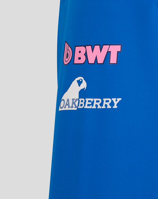 Close up of blue BWT Alpine rain jacket showing pink BWT logo and Oakberry branding on the sleeve area
