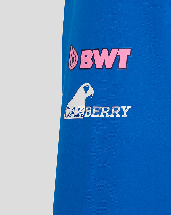 Close up of blue BWT Alpine rain jacket showing pink BWT logo and Oakberry branding on the sleeve area