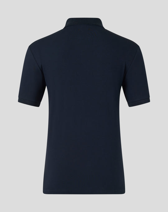 Back view of navy travel polo showing clean silhouette and minimal branding