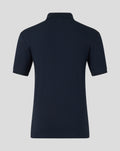 Back view of navy travel polo showing clean silhouette and minimal branding