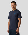Male model wearing navy regular fit T shirt with small blue A logo on the left chest
