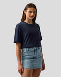 Female model wearing navy Night Sky T shirt with embroidered A on the chest and large back branding visible