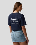 Back view of a woman wearing navy BWT Alpine Regular Fit T shirt with large white Formula One Team branding on the back.