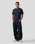 Front view of a man in navy BWT Alpine Regular Fit T shirt with a small blue chest logo.