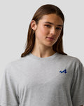Female model wearing grey marl Unisex Regular Fit Core T Shirt with blue embroidered A on the left chest.