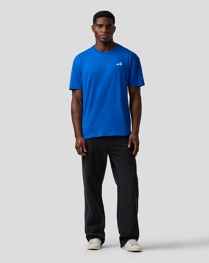 Front view of a man wearing lapis blue BWT Alpine relaxed fit T shirt with embroidered A logo on the chest