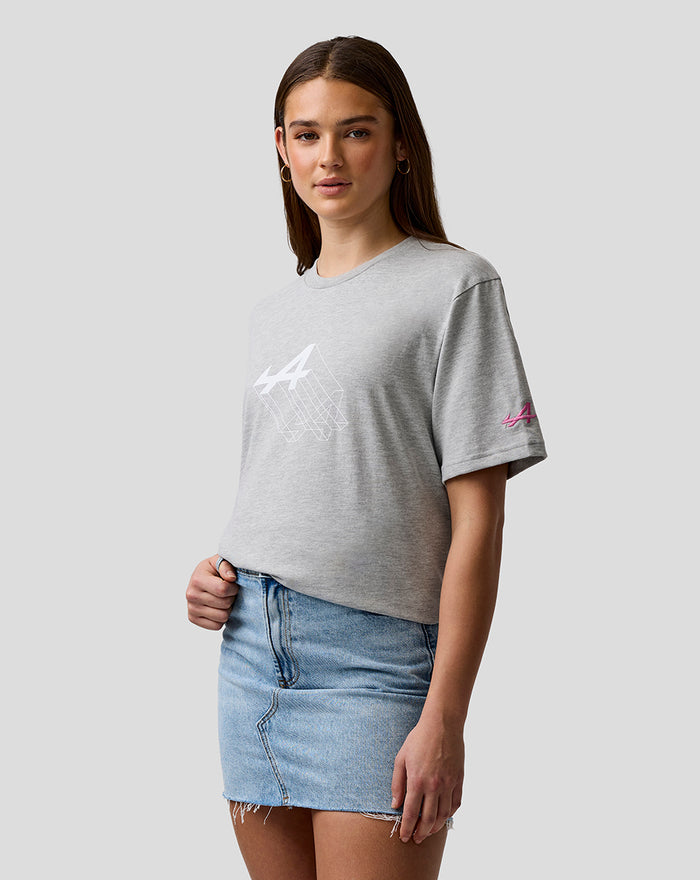 Woman wearing grey graphic T shirt with Alpine A chest print and pink A sleeve logo.