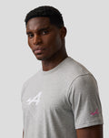 Profile of a man in a grey T shirt showing a geometric Alpine A graphic on the chest and a pink A logo on the sleeve
