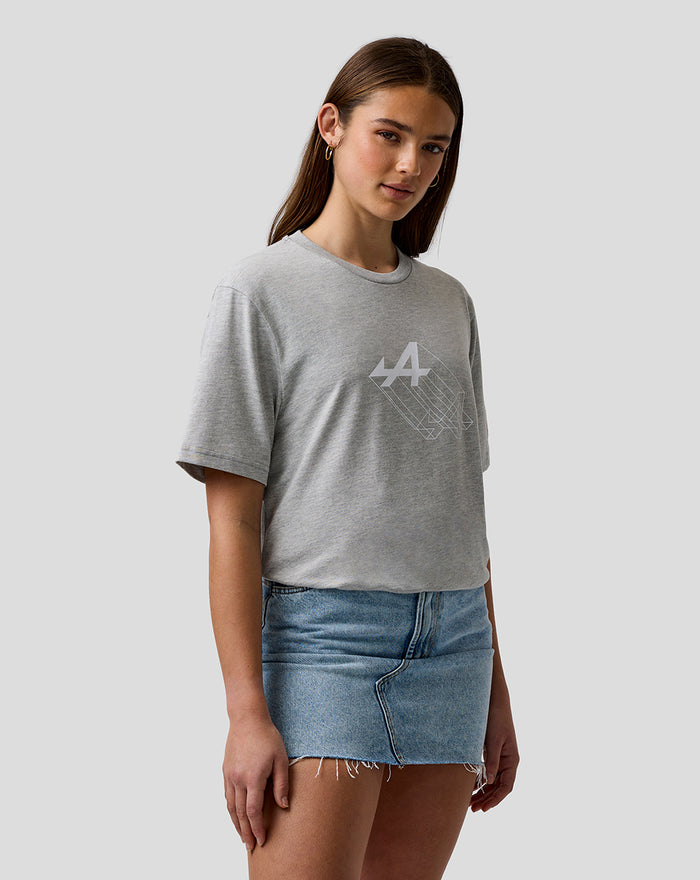 Woman wearing grey marl graphic T shirt with large white Alpine chest print and pink Alpine A embroidery on sleeve