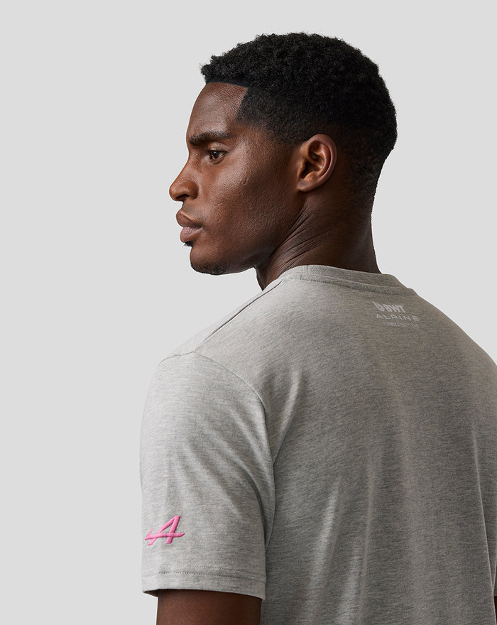 Side back view of a man in a grey T shirt with Alpine branding on the upper back