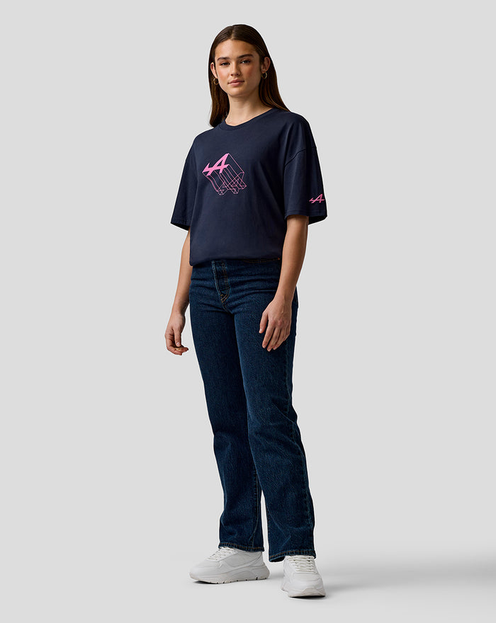 Model wearing navy Night Sky unisex relaxed fit T shirt with pink Alpine logo on chest and left sleeve