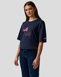 Front view of a woman in a navy relaxed fit T shirt with pink Alpine graphic on chest and sleeve logo