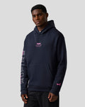 Male model wearing navy BWT Alpine graphic hoodie with pink chest logo and sleeve graphics and a kangaroo pocket