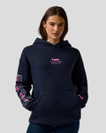 Female model in navy BWT Alpine graphic hoodie with chest logo and bold sleeve artwork