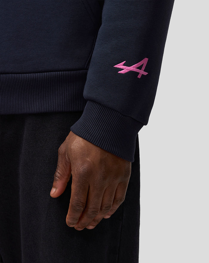 Close-up of navy hoodie sleeve showing pink embroidered A near the cuff.